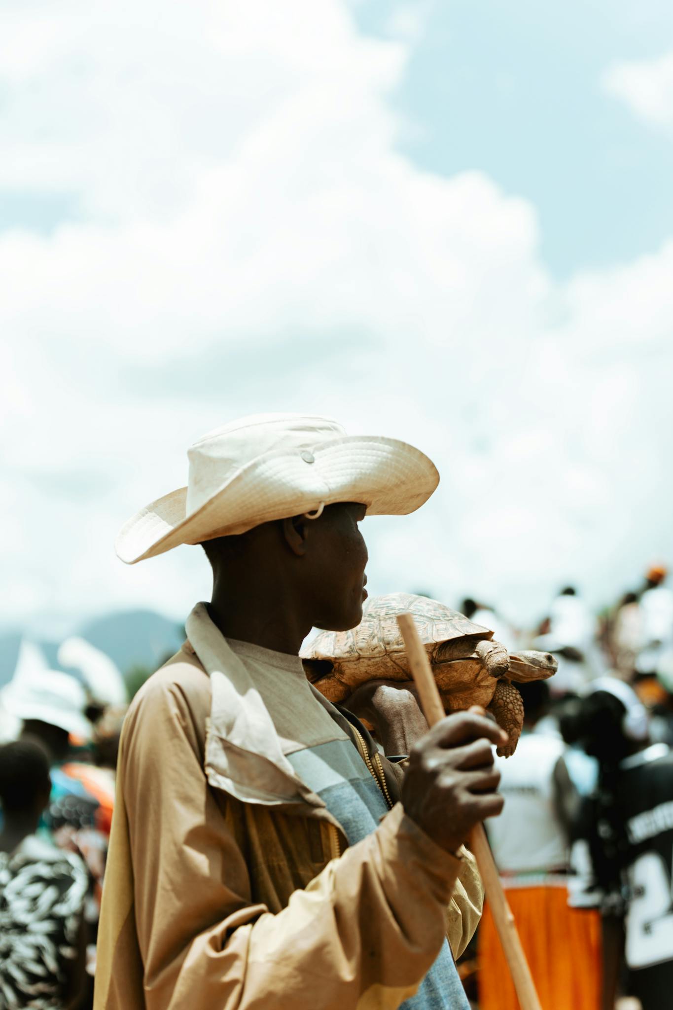 African herdsman in traditional attire holding a staff in Nakapiripirit, Uganda.